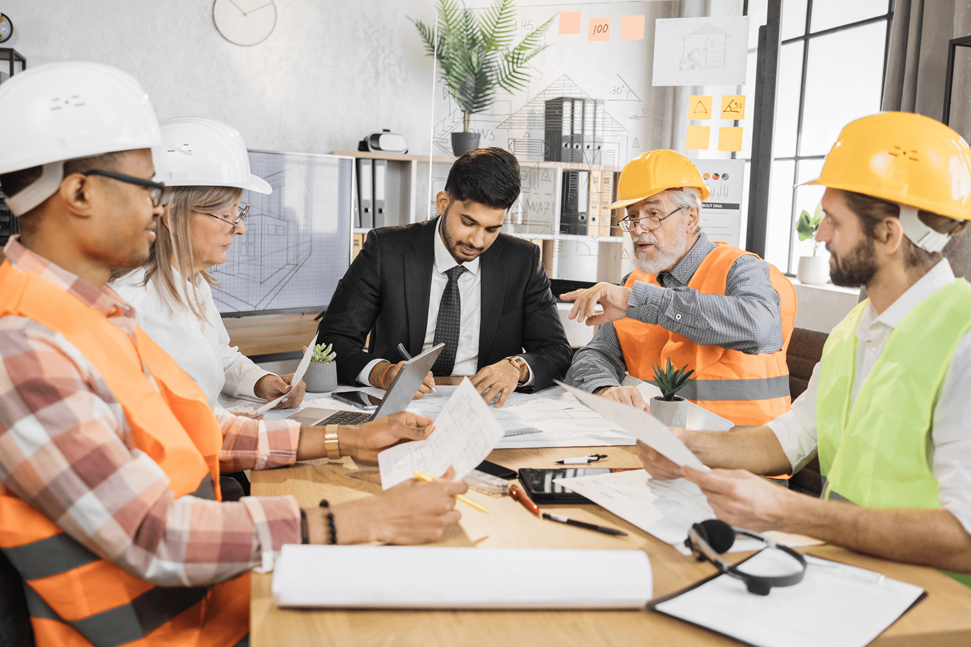 Construction team discussing project at table.
